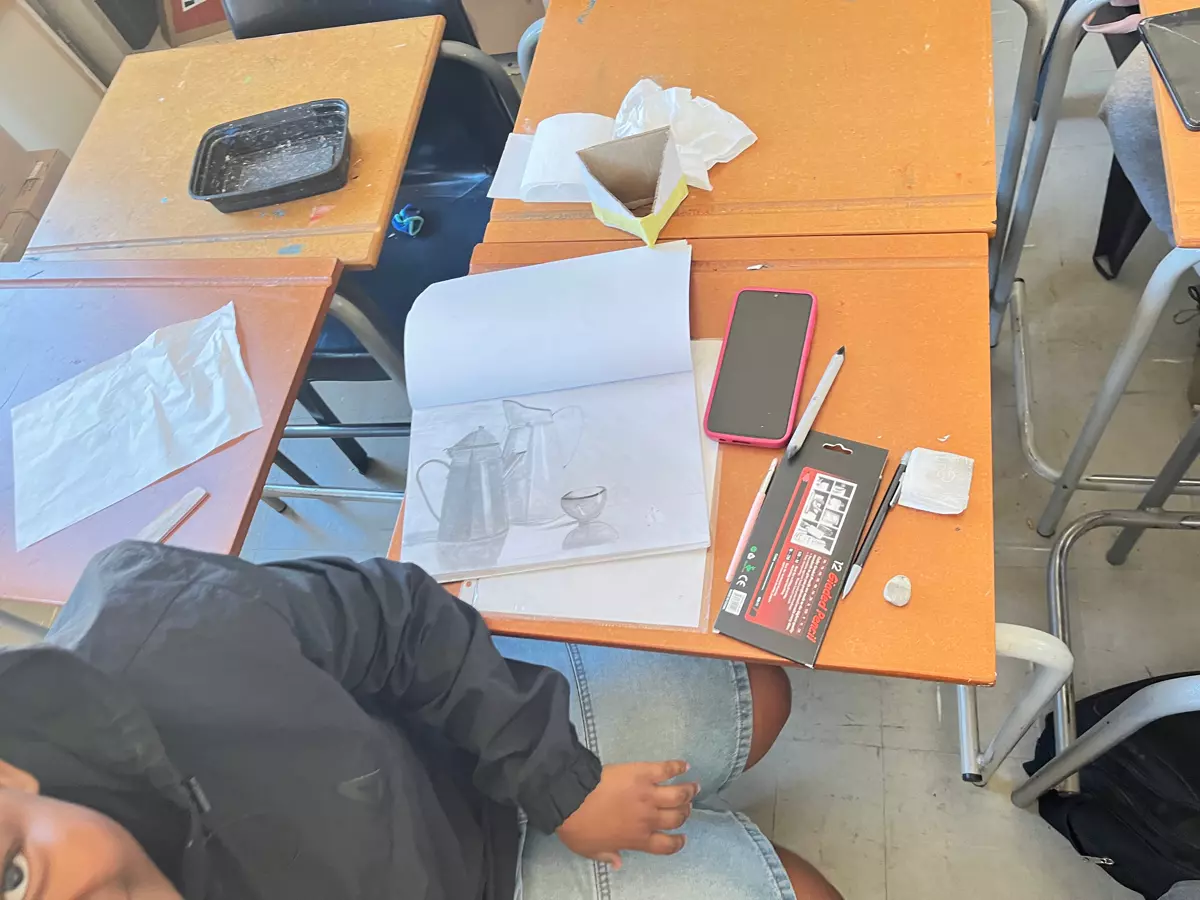 Classroom desk with art supplies and materials