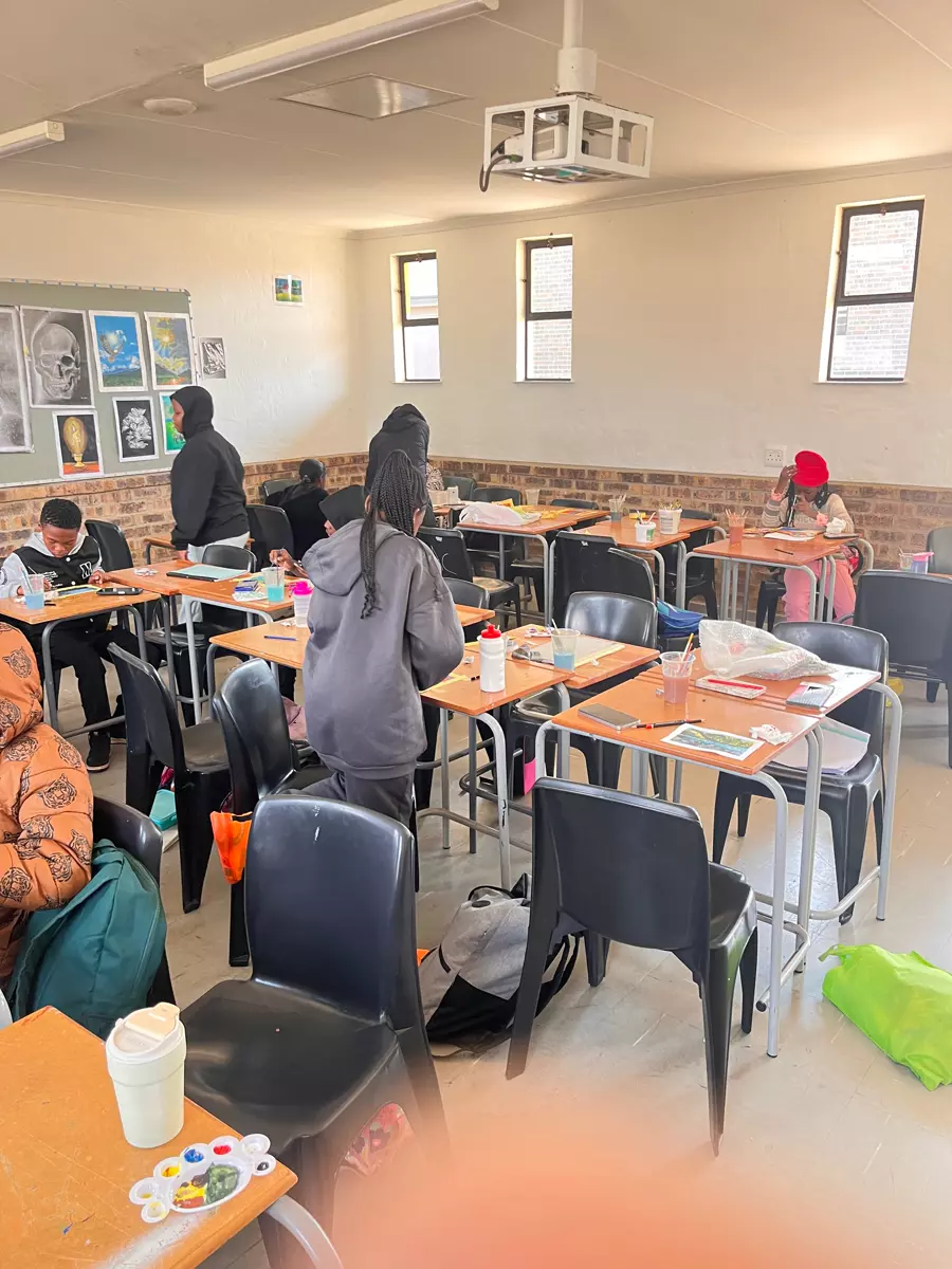 Students in a classroom working on art projects at their desks